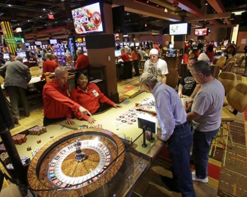 People playing table games inside the Lady Luck Casino Nemacolin in Pennsylvania