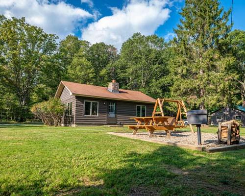 cabin with play area for kids in front