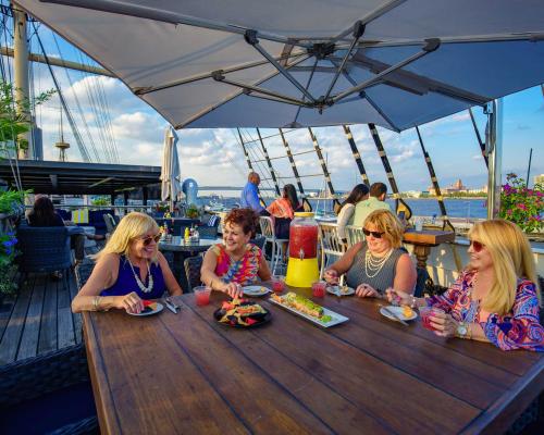 ladies having lunch on river side deck