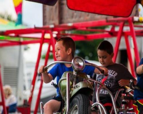 cheerful kids having fun rides at jefferson county fair