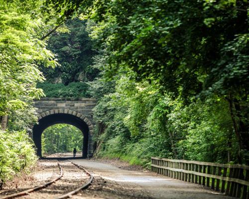 rail tracks trail through tunnel