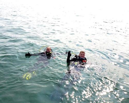 two guys scuba diving in lake