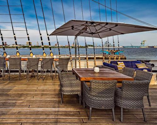 dining area with chairs and desk on deck next to river