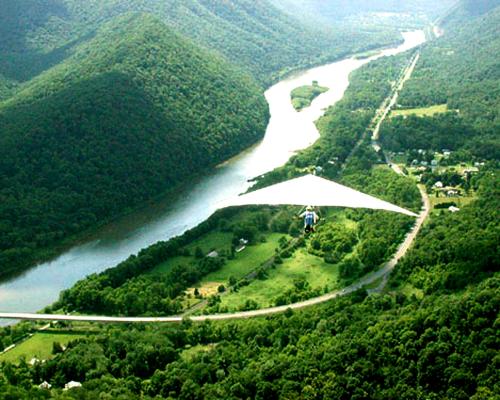 Hang gilder ride over mountain and river