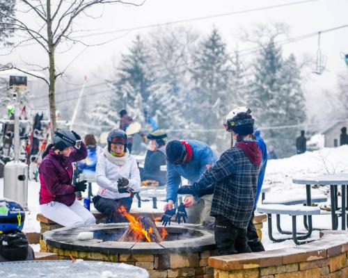 people warming up from camp fire