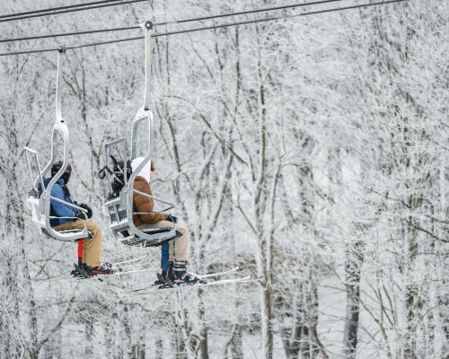 two persons riding High Chair Ski Lift
