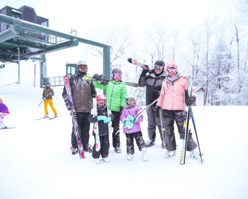 A group of people posing for a photo with Ski Gear on