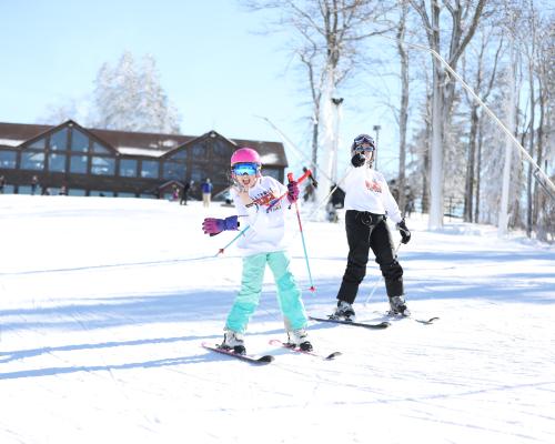two Kids enjoying Skiing