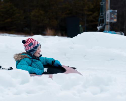 A kids enjoying Snow tubing