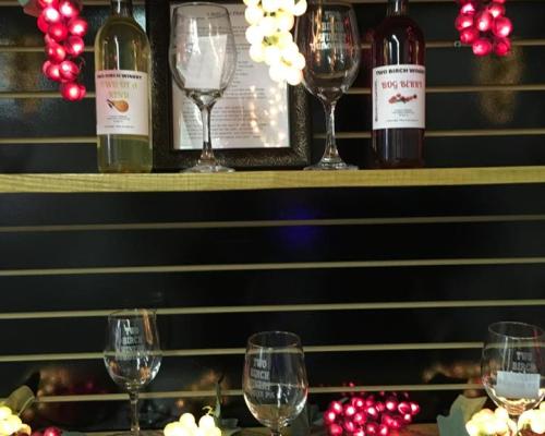 Wine bottle with glasses in shelves
