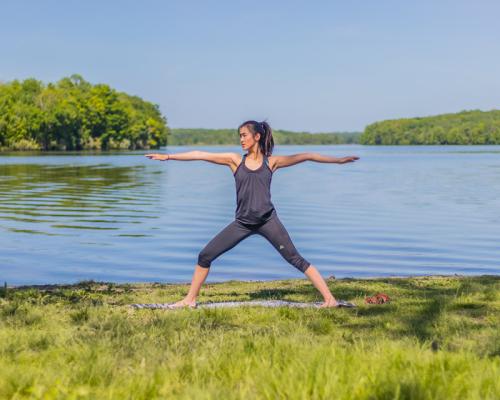 a women doing yoga by Lake Nockamixon