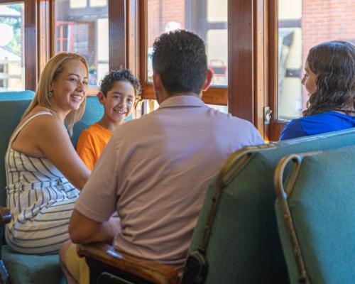 family sitting seats inside train car