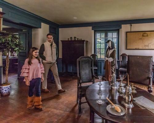 a father daughter duo looking thru Pennsbury manor inside
