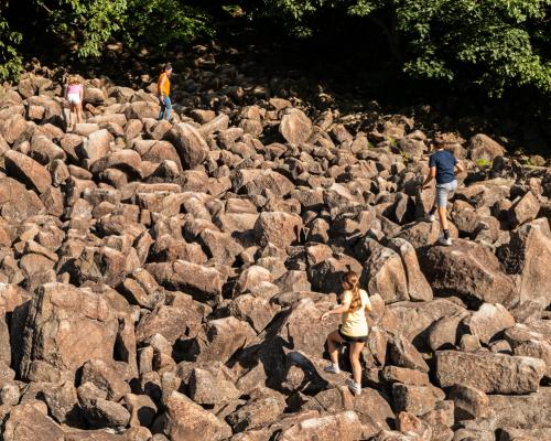 tourist climbing rocks at Ringing rock park
