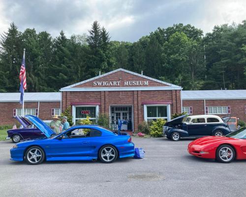 Exterior of a museum with cars in the front