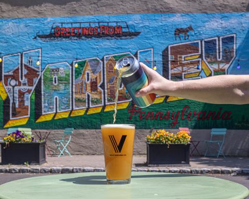 pouring beer into a glass from can