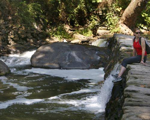 a person sitting near a creek at Wissahickon Valley Park