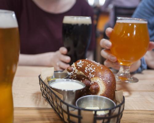pretzel bites and beer in a glass