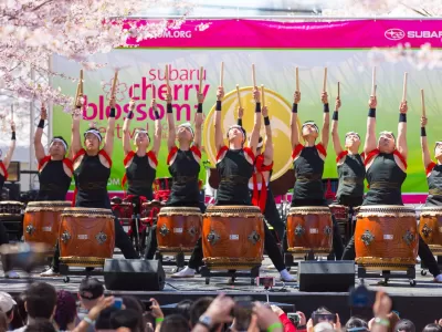 Group of men dressed in traditional Japanese attire playing drums