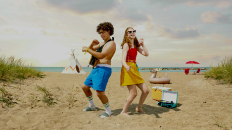 Two kids dancing on a beach