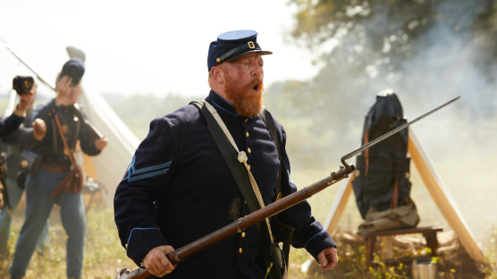 A civil war soldier carrying a rifle