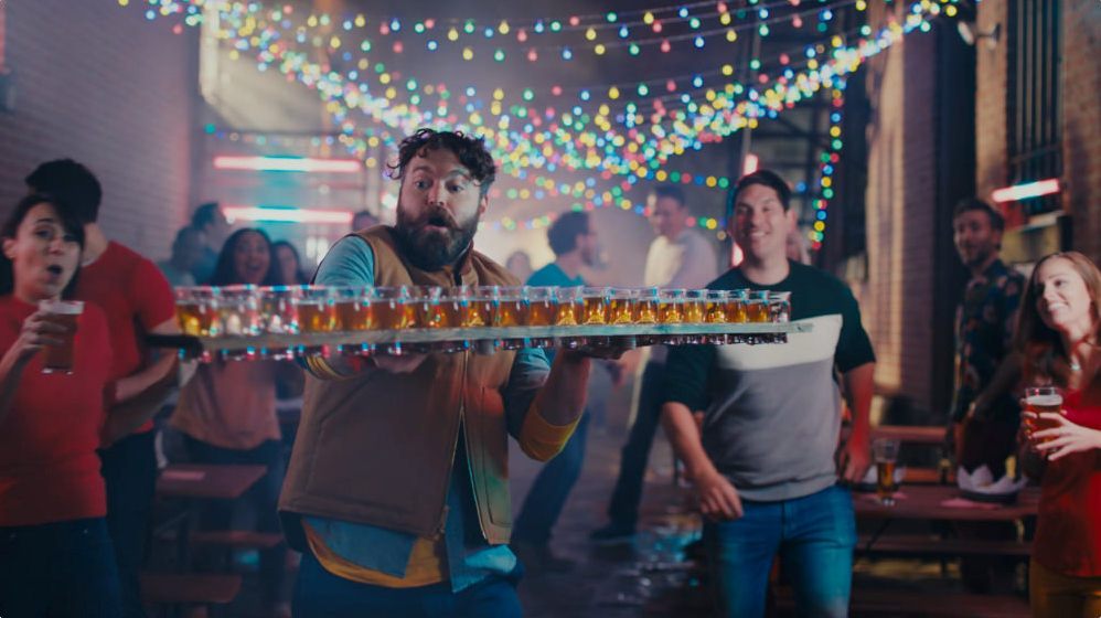 Man holding a tray of drinks