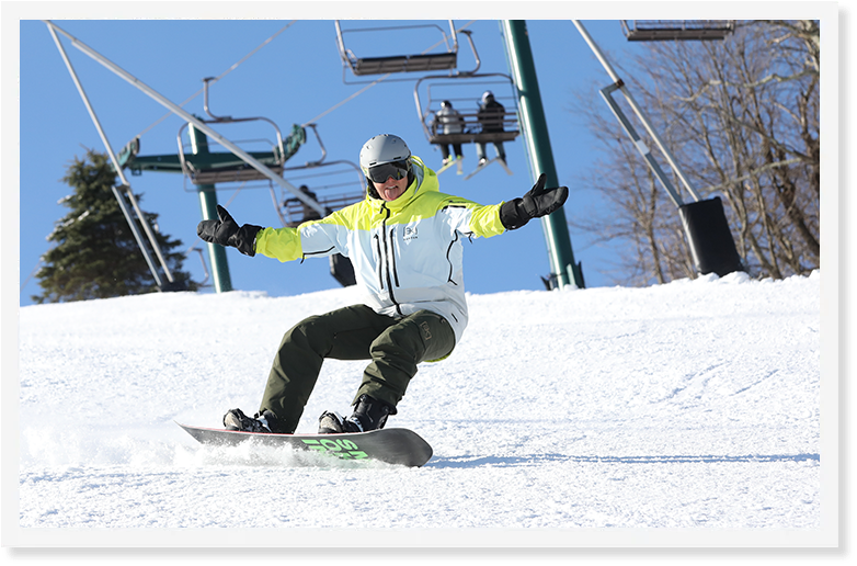 A person snowboarding down a snowy hill